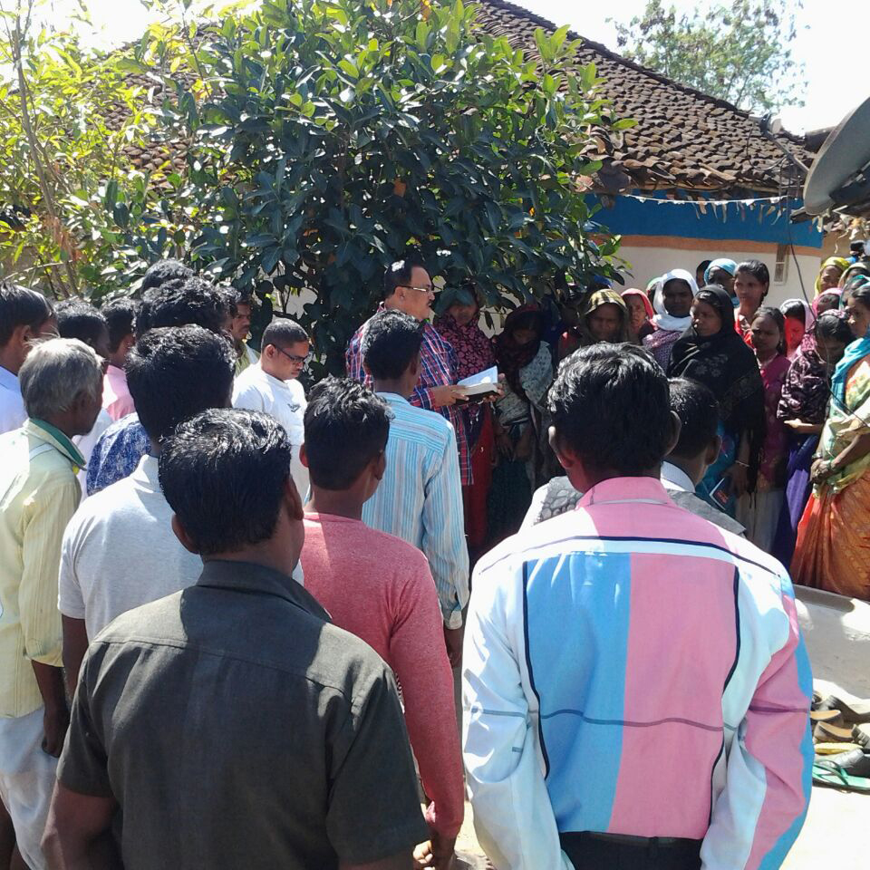pastor preaching in a village